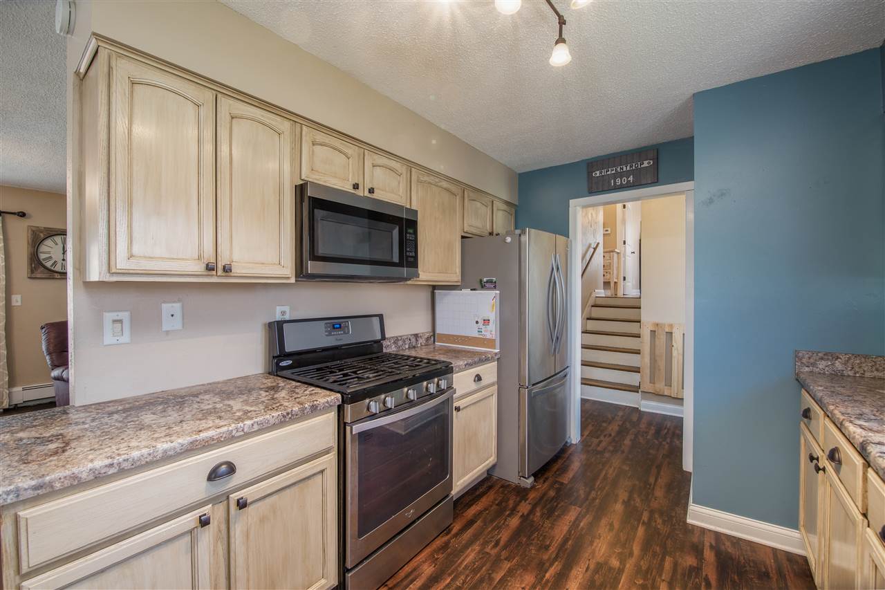 6775 South Sarah Avenue Rochelle, IL 61068 - Photo 14 of 26 a kitchen with granite countertop a refrigerator and a sink