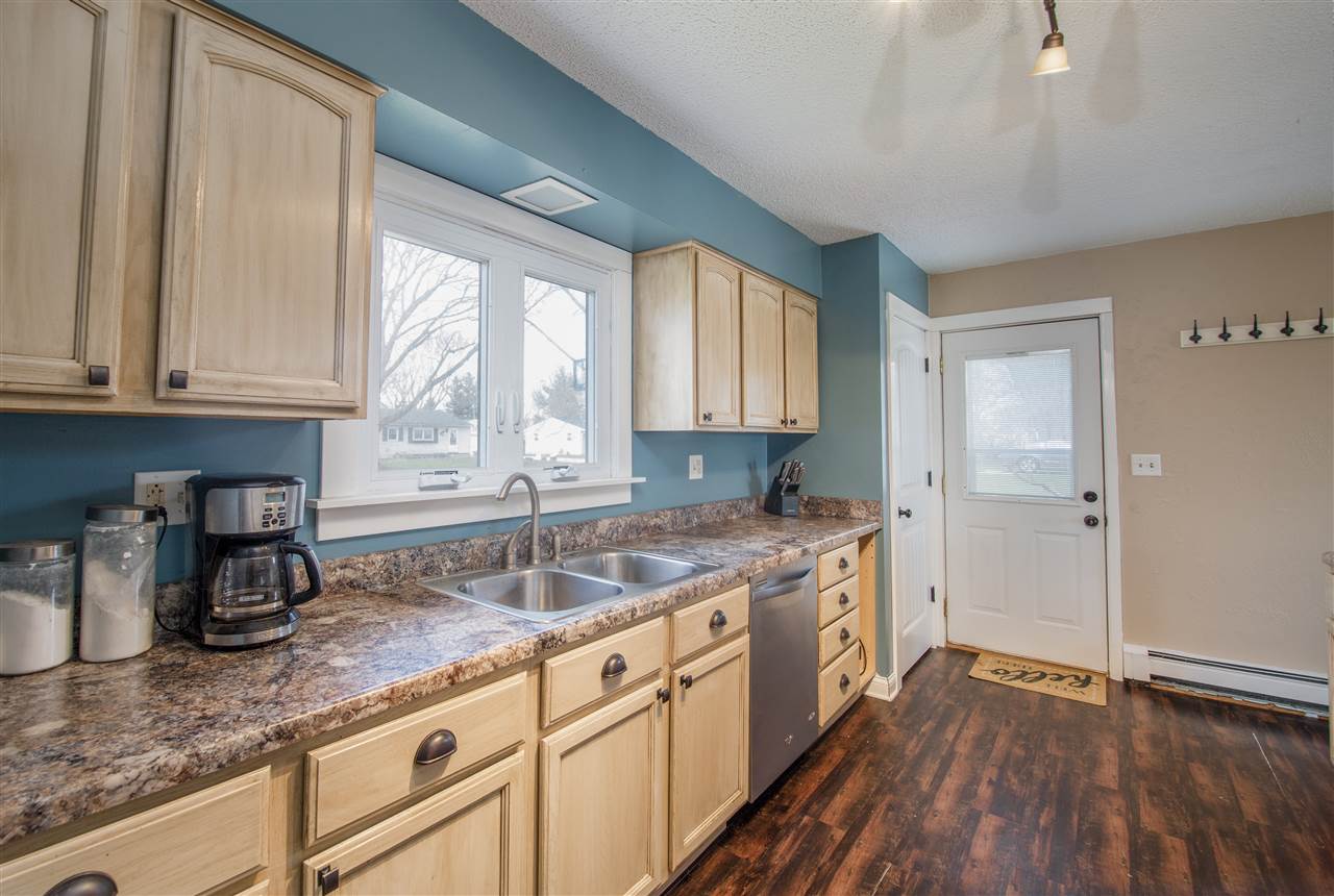 6775 South Sarah Avenue Rochelle, IL 61068 - Photo 15 of 26 a kitchen with granite countertop wooden cabinets a sink and a window