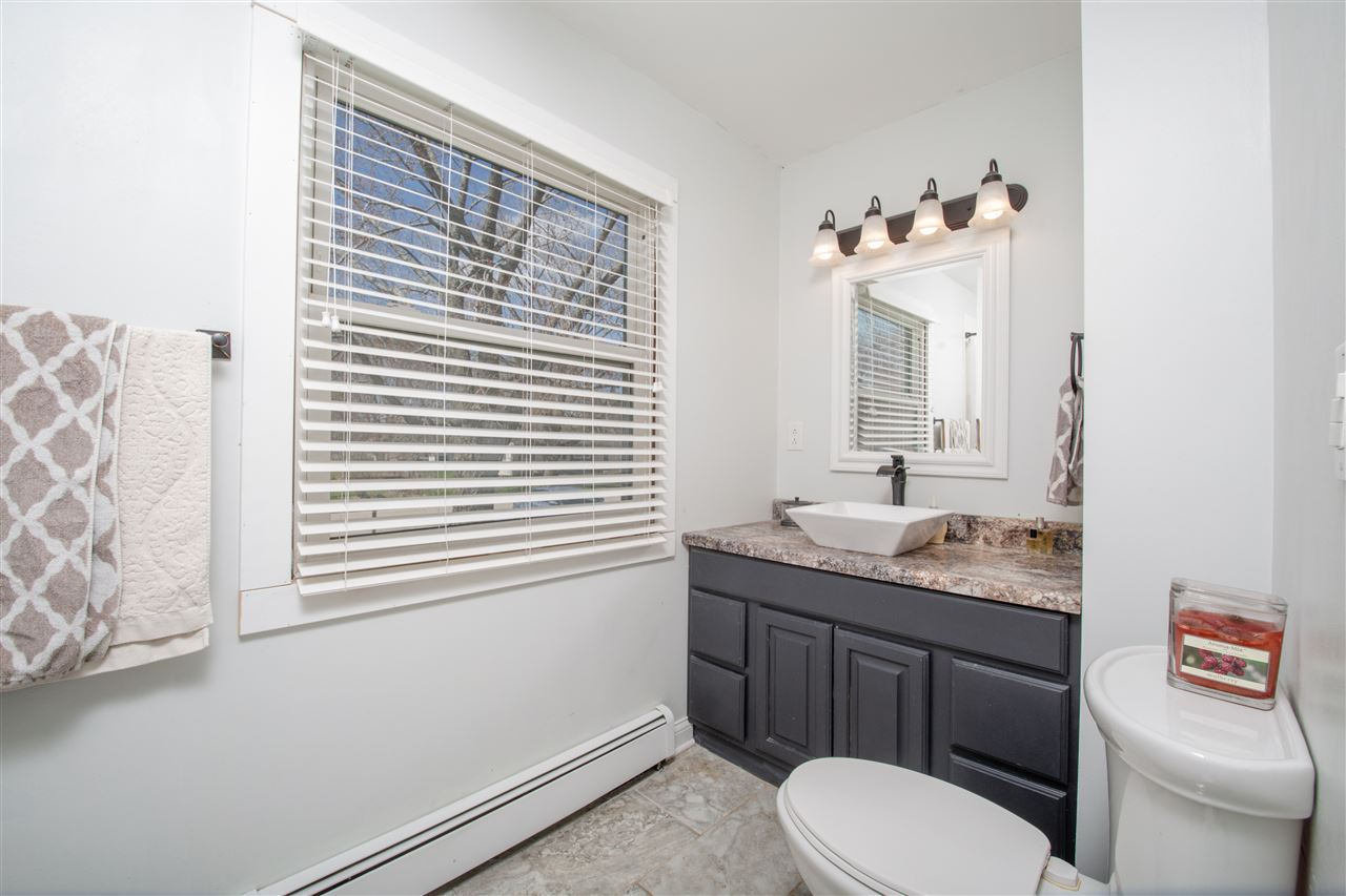 6775 South Sarah Avenue Rochelle, IL 61068 - Photo 16 of 26 a bathroom with a granite countertop sink toilet and mirror