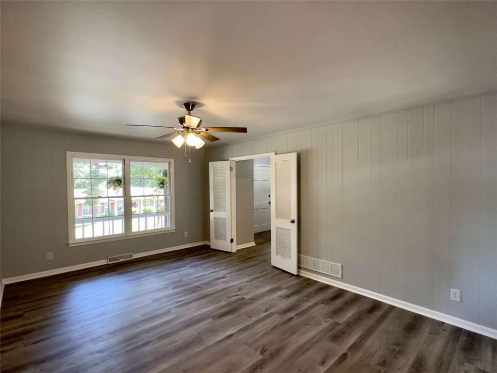 6 Westlyn Drive Rome, GA 30165 - Photo 18 of 25 an empty room with wooden floor chandelier fan and windows