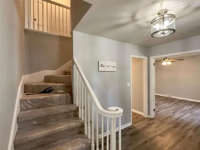a view of entryway and hall with wooden floor