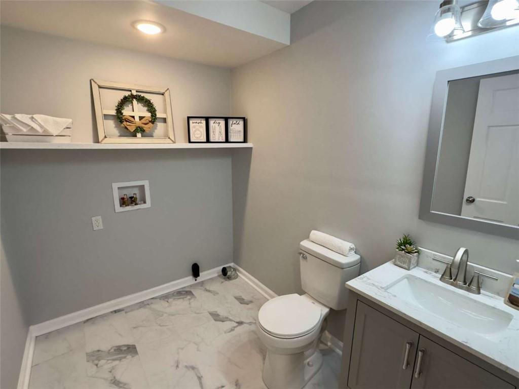 6 Westlyn Drive Rome, GA 30165 - Photo 3 of 25 a bathroom with a granite countertop sink and a toilet