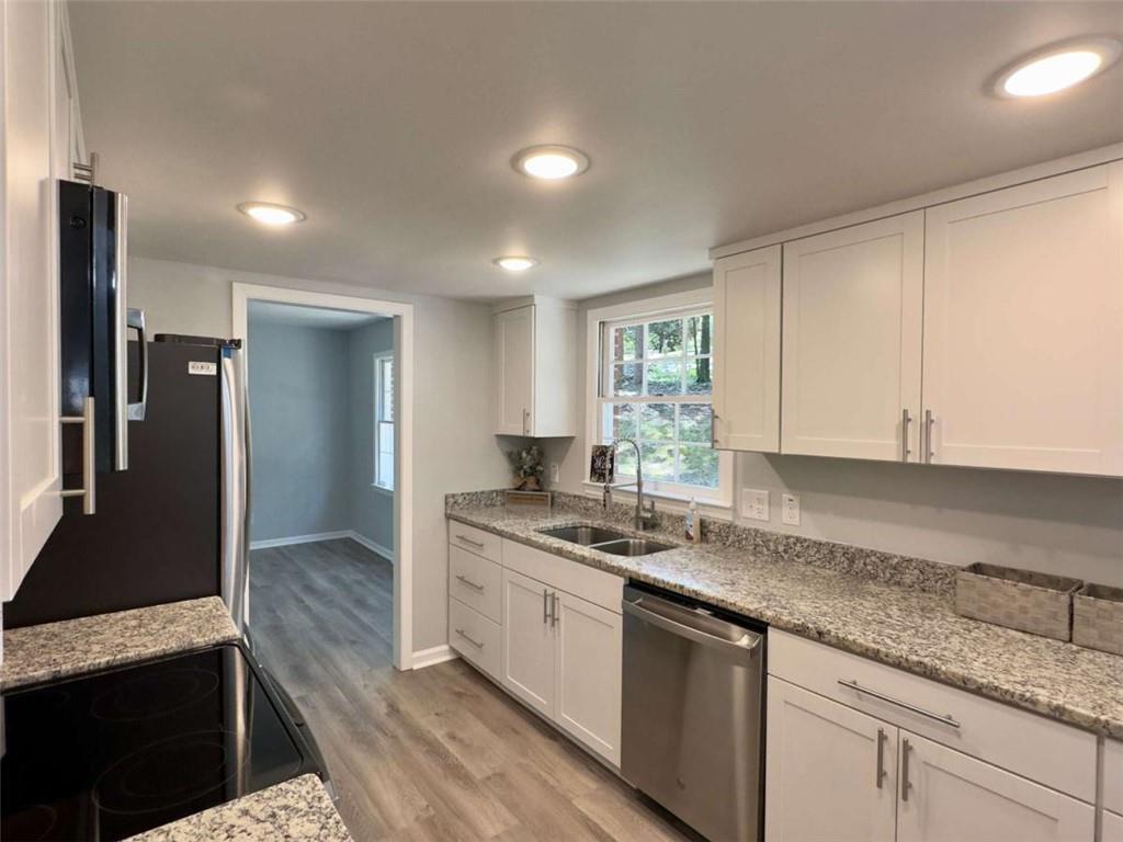 6 Westlyn Drive Rome, GA 30165 - Photo 6 of 25 a kitchen with stainless steel appliances granite countertop a sink stove and refrigerator