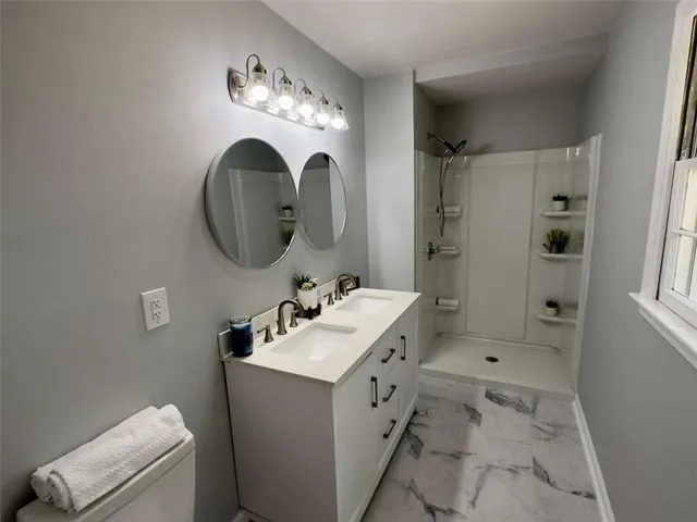 a bathroom with a sink mirror and vanity