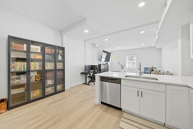 a kitchen with stainless steel appliances granite countertop a stove and a sink