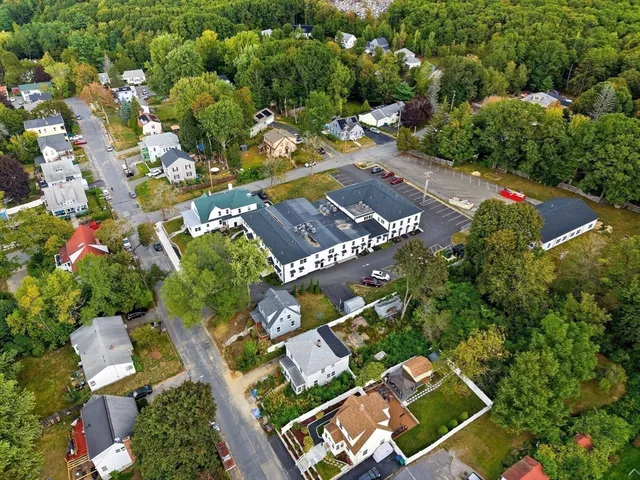 an aerial view of a house with a yard