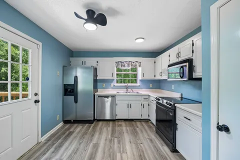 a kitchen with stainless steel appliances granite countertop a stove and a refrigerator