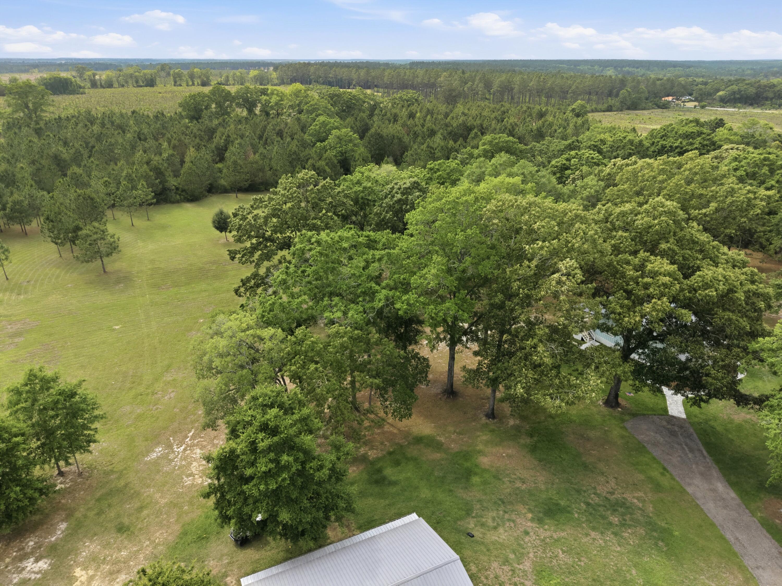 261 Wilkerson Road DeFuniak Springs, FL 32433 - Photo 16 of 76 a view of a lake with an outdoor space