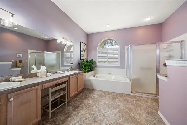 a open kitchen with stainless steel appliances granite countertop a dining table chairs and a refrigerator