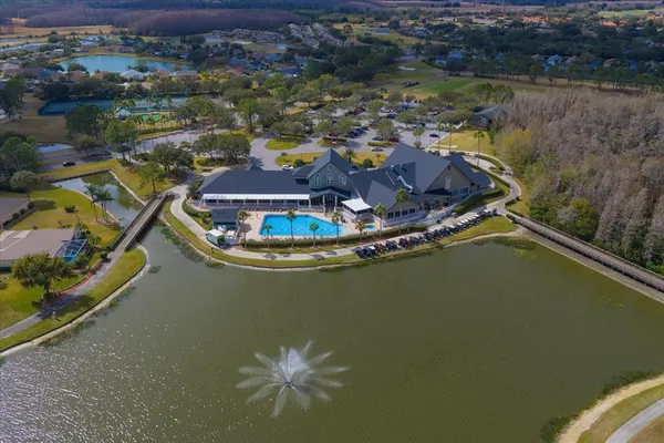 a front view of a house with a yard and mountain view