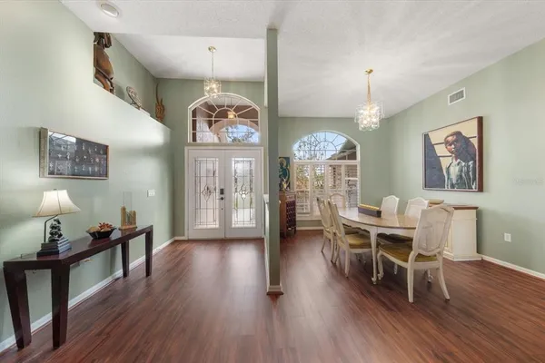 a large bedroom with a bed and a chandelier