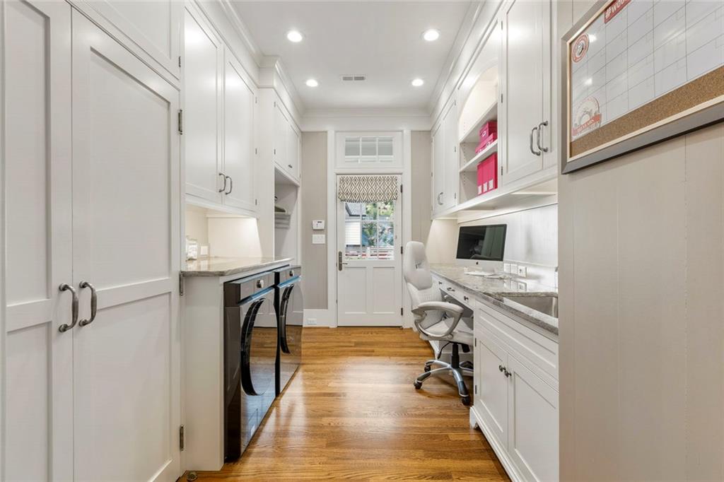 1982 West Rugby Avenue Atlanta, GA 30337 - Photo 23 of 42 a hallway with stainless steel appliances granite countertop hardwood floor and a sink