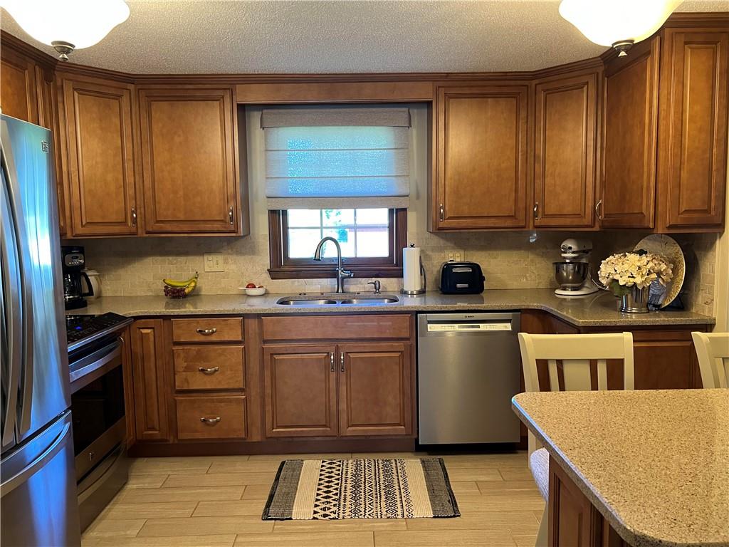 200 Courtland Road Indiana, PA 15701 - Photo 2 of 42 a kitchen with granite countertop wooden cabinets and stainless steel appliances