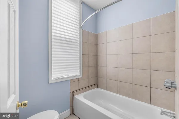 a bathroom with a bathtub and a toilet
