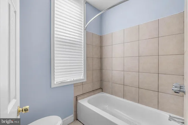 a bathroom with a bathtub and a toilet