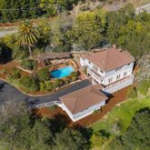an aerial view of house with yard swimming pool and outdoor seating