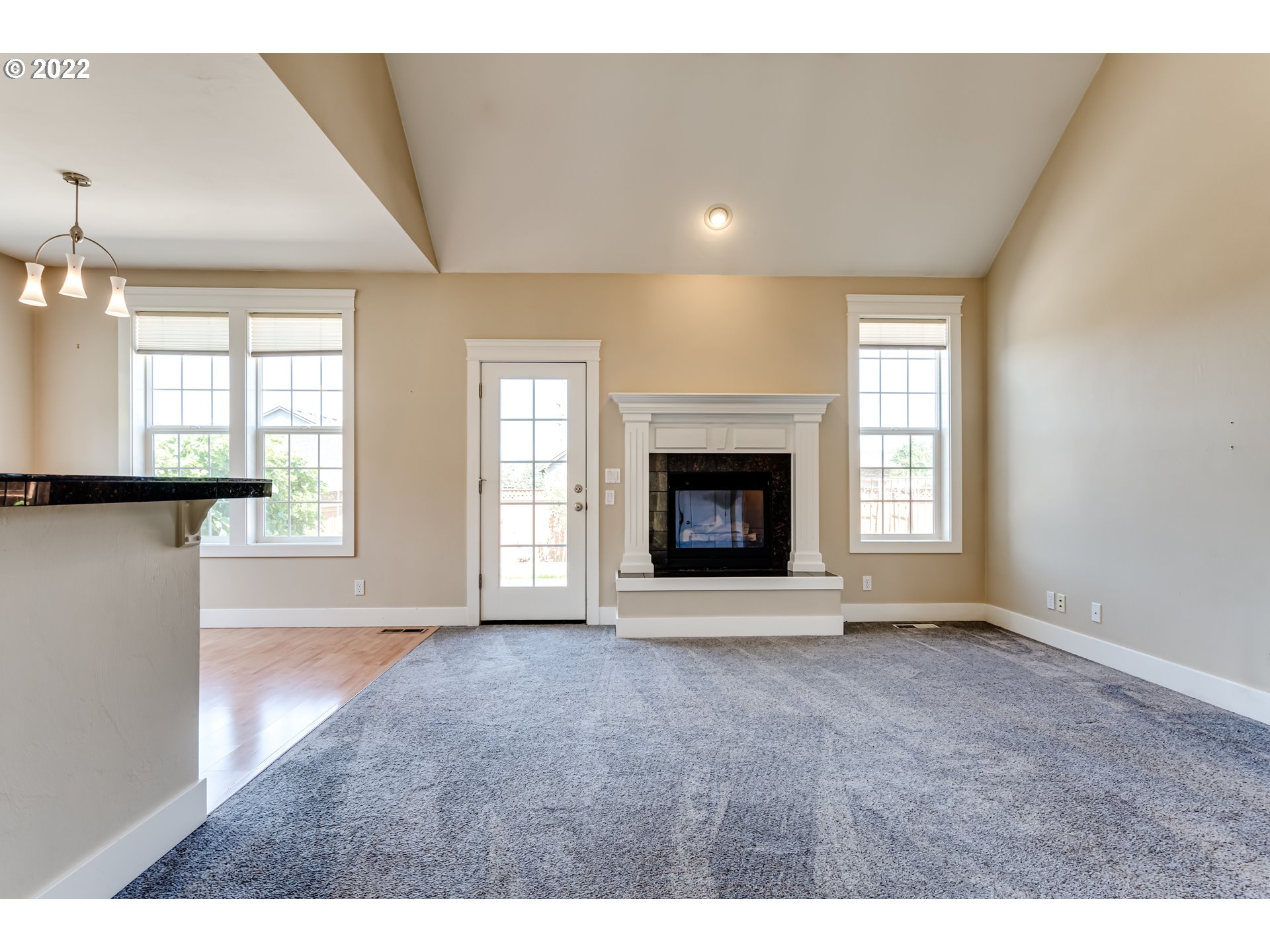 4750 Rocky Road Springfield, OR 97478 - Photo 12 of 32 an empty room with windows and fireplace