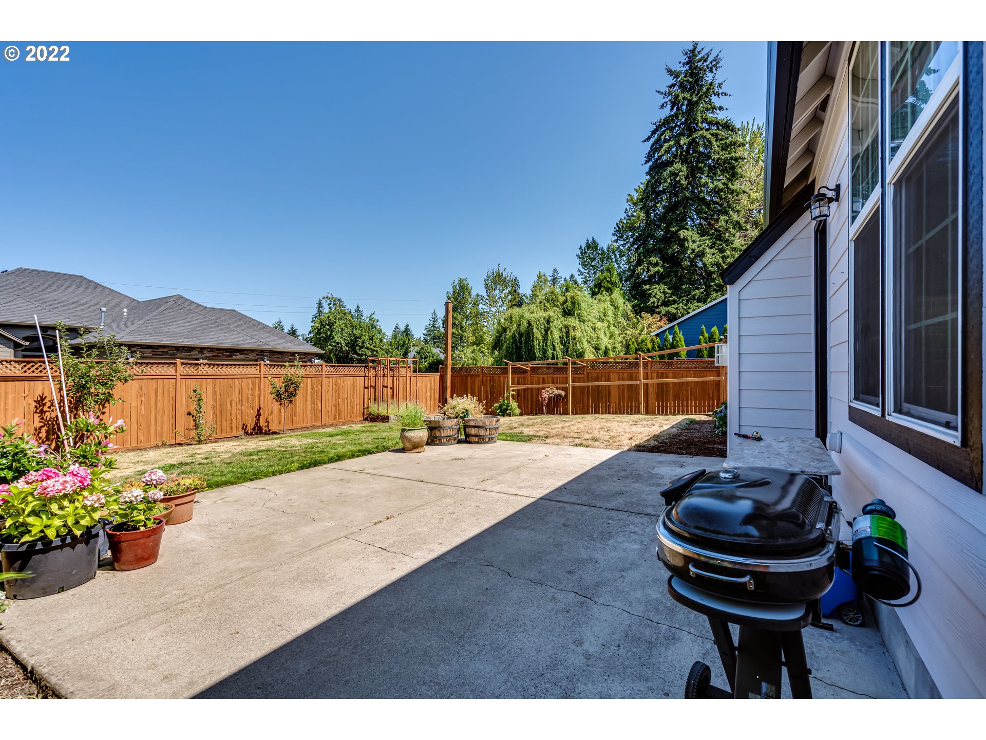 4750 Rocky Road Springfield, OR 97478 - Photo 29 of 32 a view of a backyard with table and chairs potted plants and a house