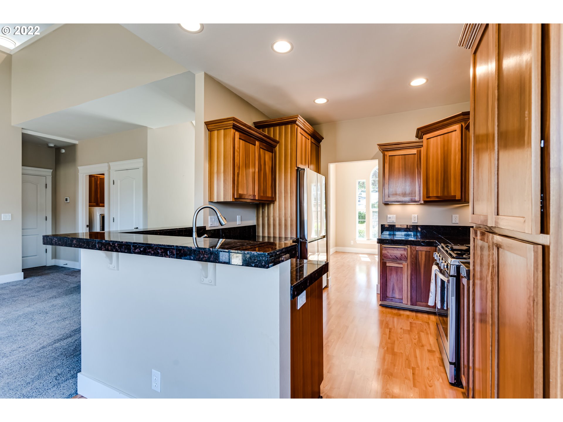 4750 Rocky Road Springfield, OR 97478 - Photo 8 of 32 a kitchen with stainless steel appliances granite countertop a refrigerator a stove and a sink