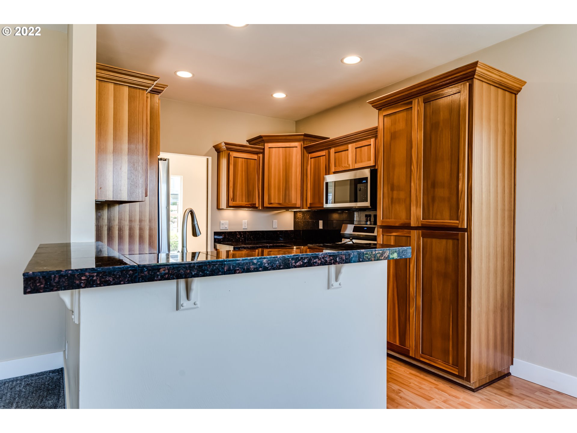 4750 Rocky Road Springfield, OR 97478 - Photo 9 of 32 a kitchen with stainless steel appliances granite countertop a refrigerator a sink and a black cabinets