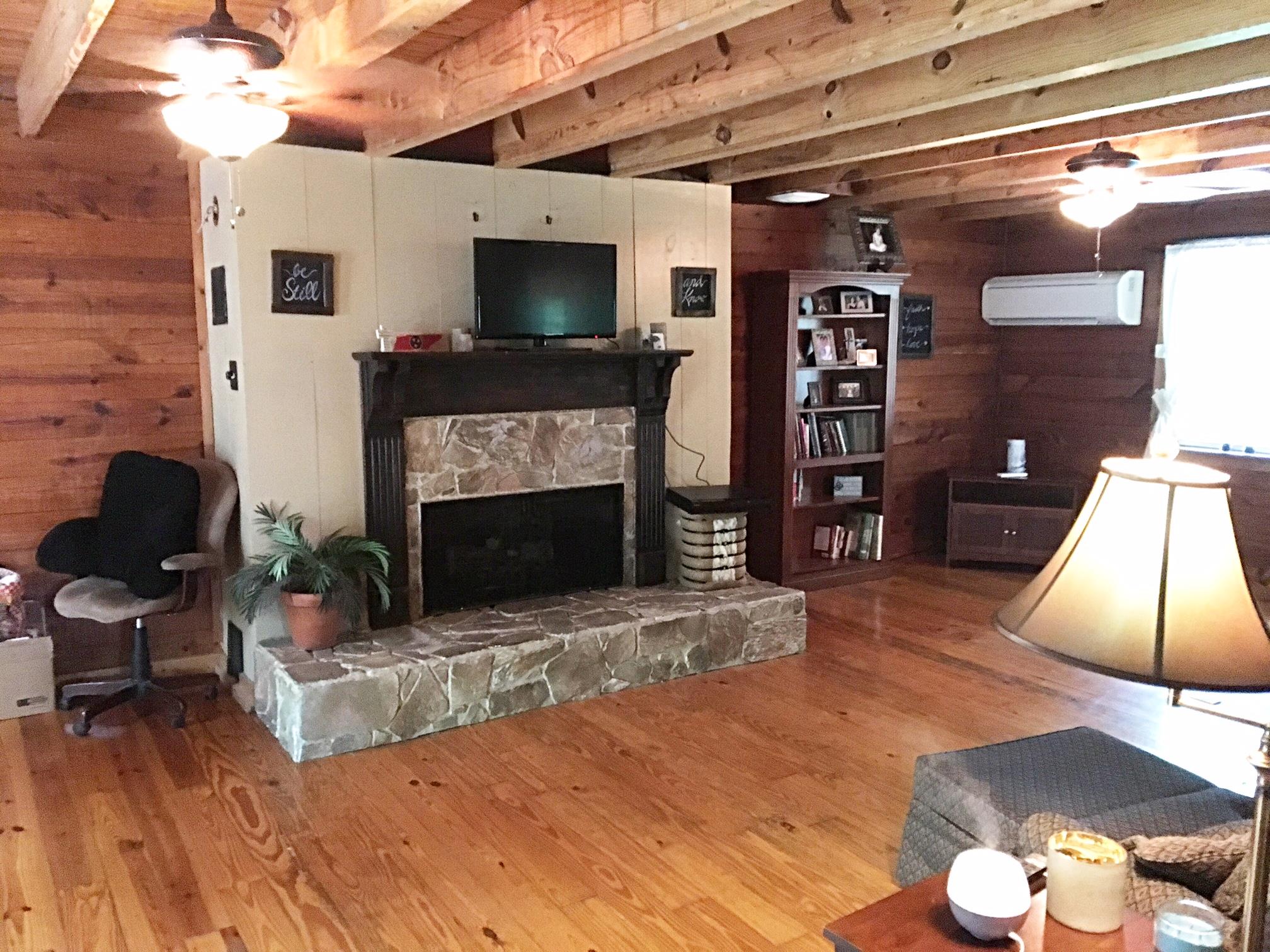 3879 Clarity Road Springfield, TN 37172 - Photo 12 of 28 a living room with furniture a flat screen tv and a fireplace