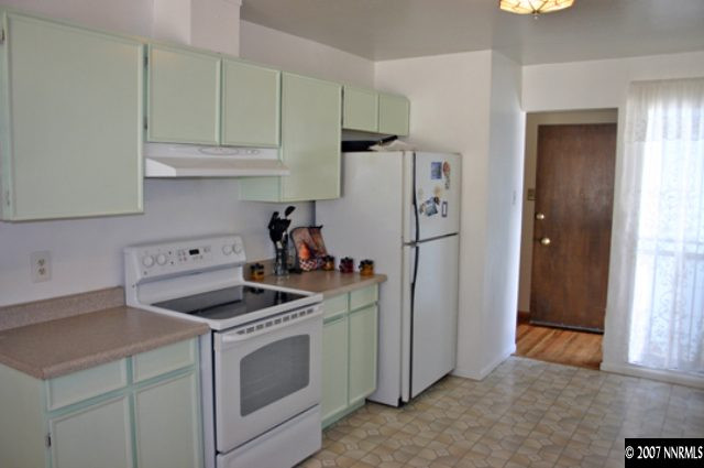 1285 Beldon Way Reno, NV 89503 - Photo 2 of 8 a kitchen with stainless steel appliances white cabinets and a refrigerator