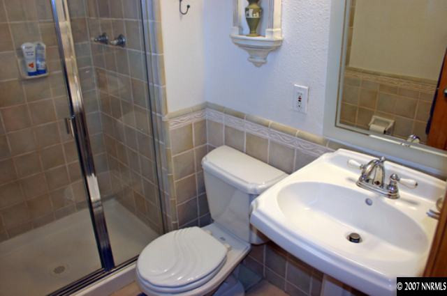 1285 Beldon Way Reno, NV 89503 - Photo 7 of 8 a white toilet sitting next to a bathroom sink