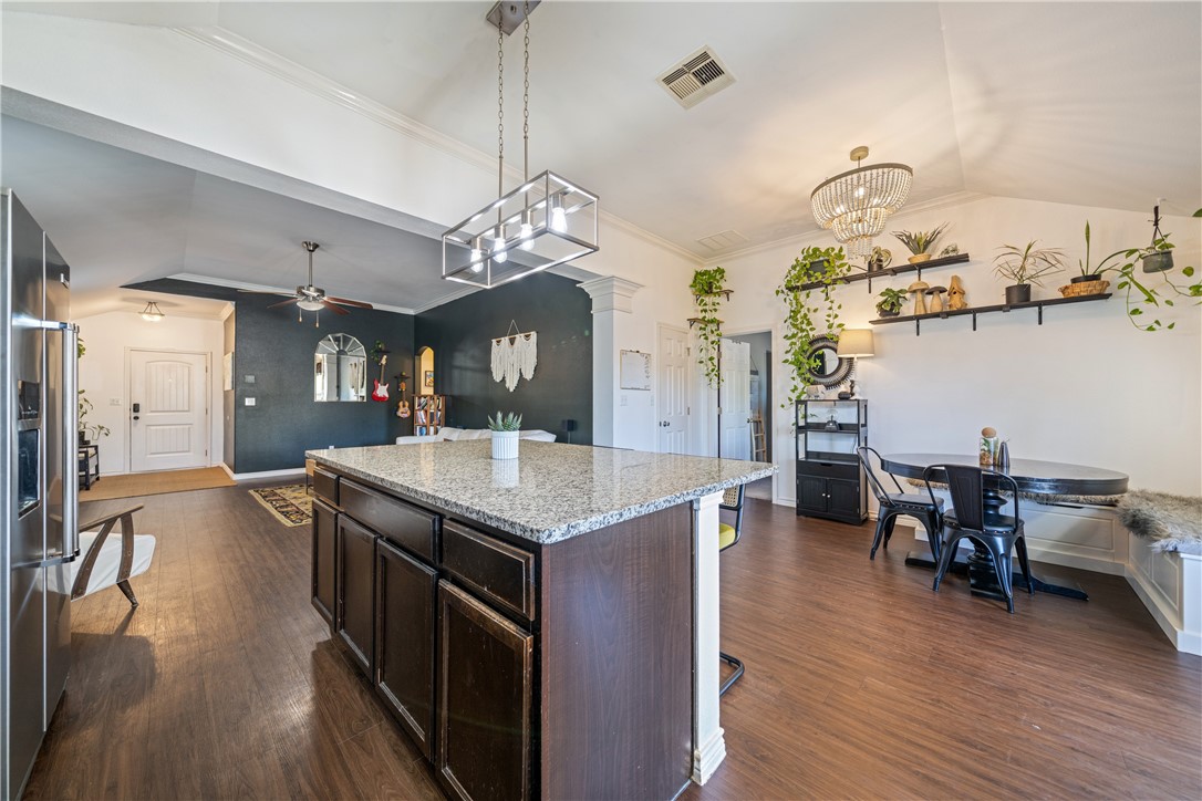 7442 Russ Lane Corpus Christi, TX 78414 - Photo 12 of 29 a kitchen with stainless steel appliances granite countertop center island and wooden floor