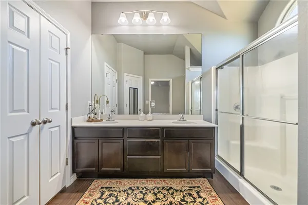 a bathroom with double vanity sinks and a mirror