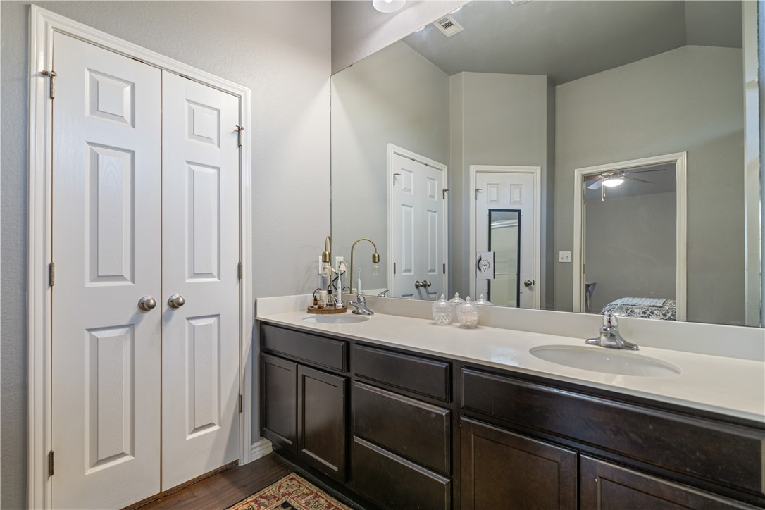 7442 Russ Lane Corpus Christi, TX 78414 - Photo 16 of 29 a bathroom with double vanity sinks and a mirror