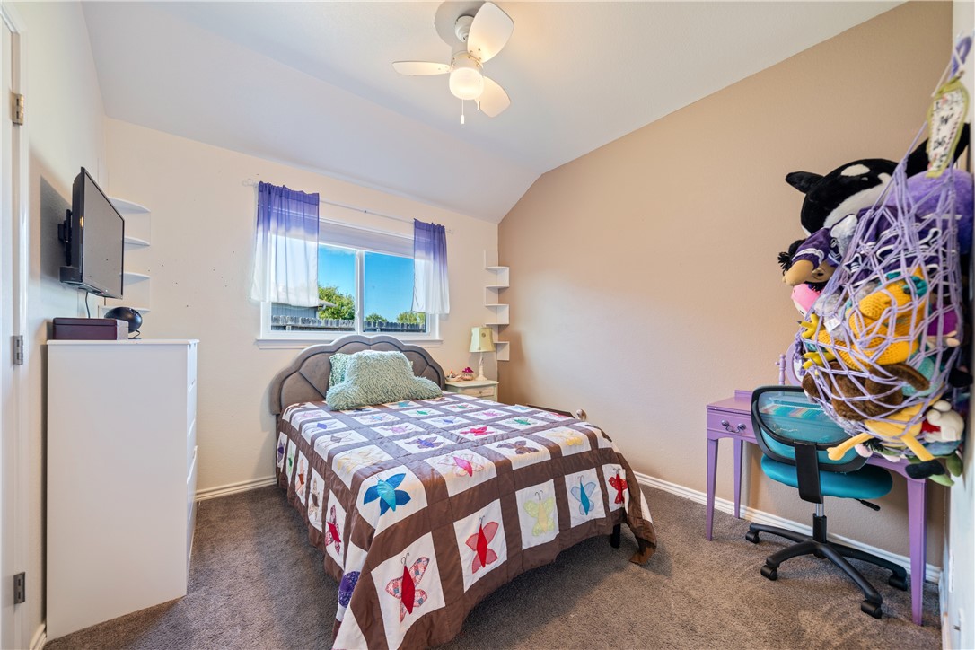 7442 Russ Lane Corpus Christi, TX 78414 - Photo 21 of 29 a bedroom with a bed and a flat tv screen on dresser