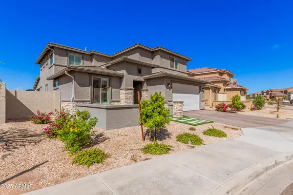 a front view of a house with a garden
