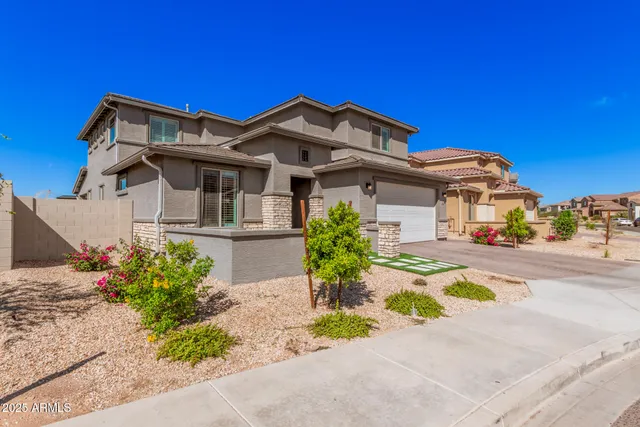 a front view of a house with a garden