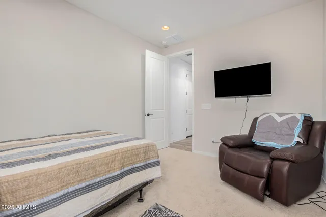 a bedroom with a flat screen tv and a bed