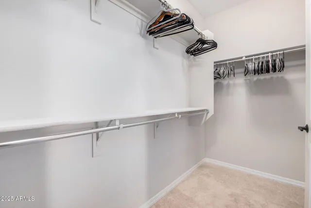 a bedroom with a bed lamp and a dresser