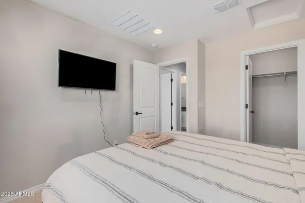 a bedroom with two beds and a window