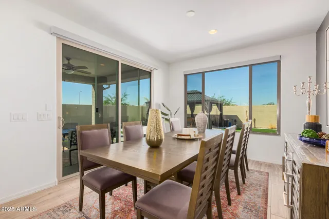 a living room with lots of furniture kitchen view and a dining table