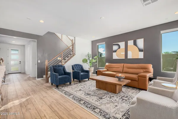 a view of a hallway with entryway wooden floor and front door
