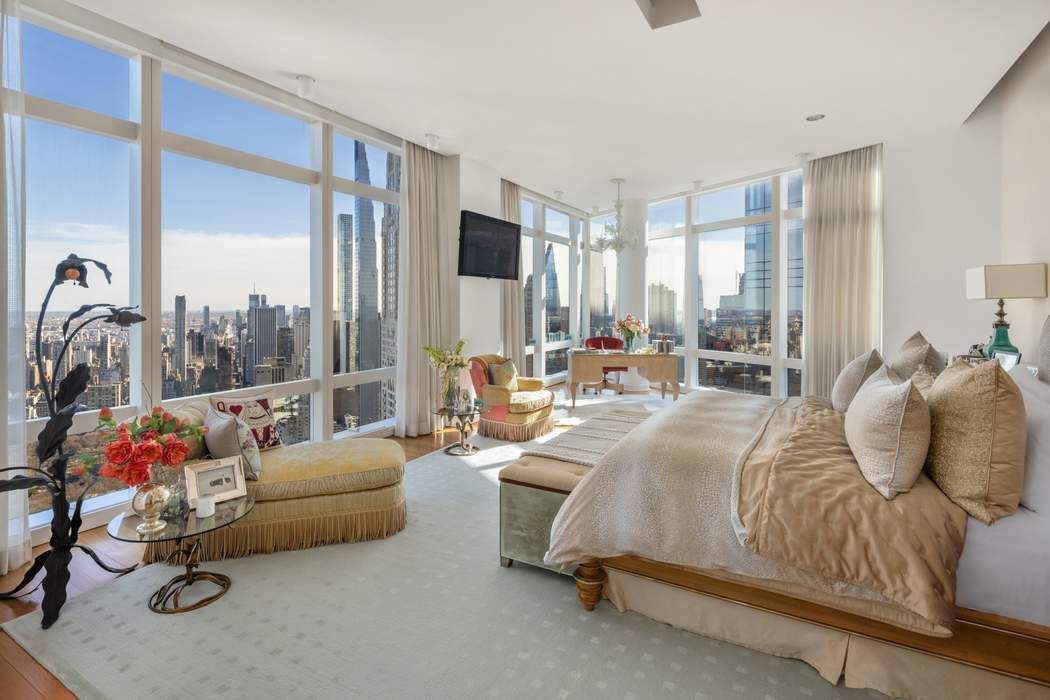 80 Columbus Circle, Unit 80 Manhattan, NY 10019 - Photo 13 of 30 a bedroom with a bed couch and large window