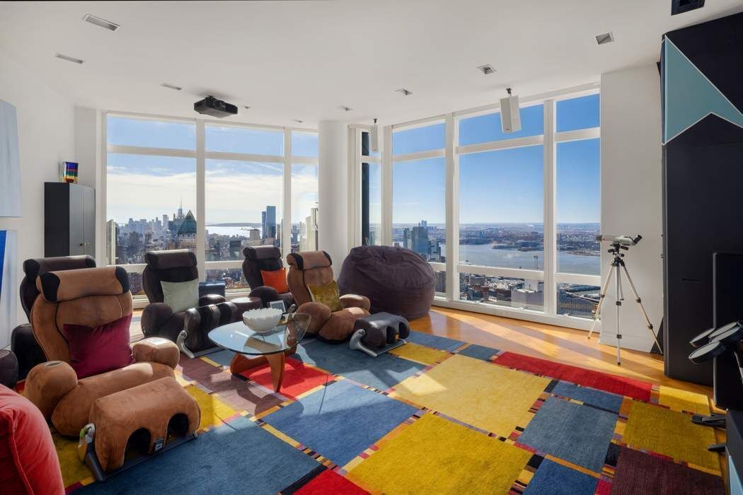 80 Columbus Circle, Unit 80 Manhattan, NY 10019 - Photo 14 of 30 a room with gym equipment and a large window