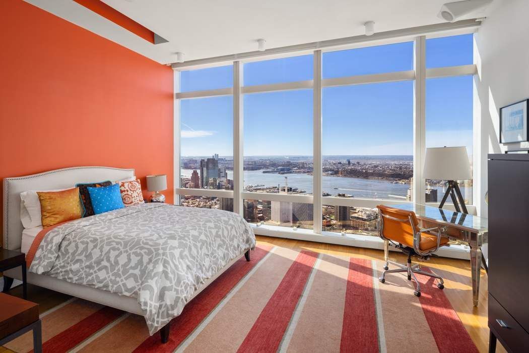 80 Columbus Circle, Unit 80 Manhattan, NY 10019 - Photo 15 of 30 a bedroom with a bed and large windows