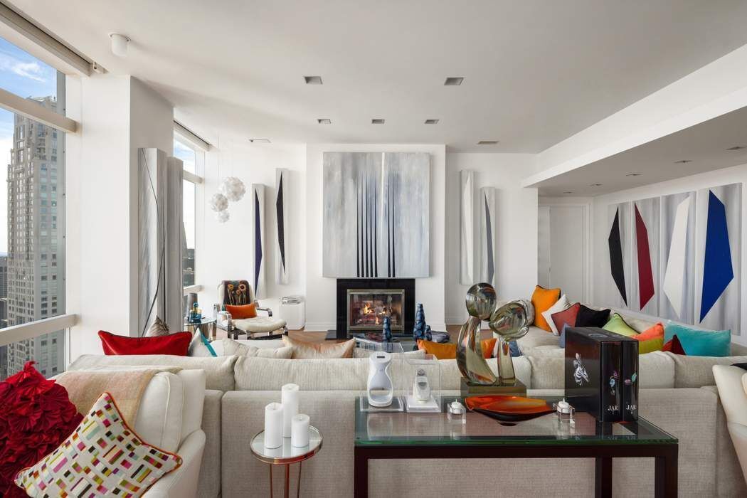 80 Columbus Circle, Unit 80 Manhattan, NY 10019 - Photo 5 of 30 a living room with furniture a fireplace and a window