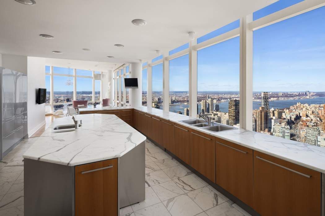 80 Columbus Circle, Unit 80 Manhattan, NY 10019 - Photo 7 of 30 a large kitchen with kitchen island a large window