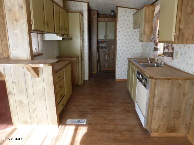 1395 South Yellow Brick Road Chino Valley, AZ 86323 - Photo 4 of 13 a kitchen with a sink stove and cabinets