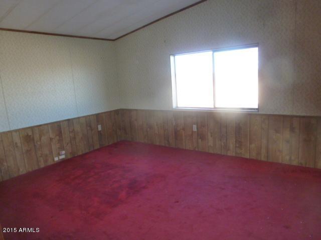 1395 South Yellow Brick Road Chino Valley, AZ 86323 - Photo 8 of 13 an empty room with a window