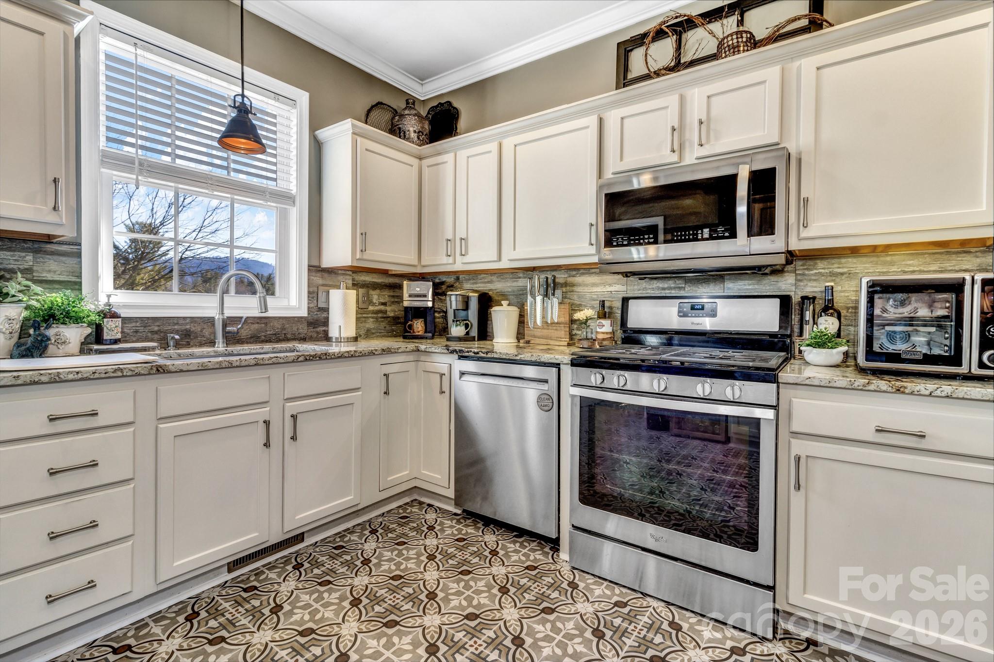 25 Union Chapel Road Weaverville, NC 28787 - Photo 13 of 43 a kitchen with stainless steel appliances granite countertop a stove microwave and cabinets
