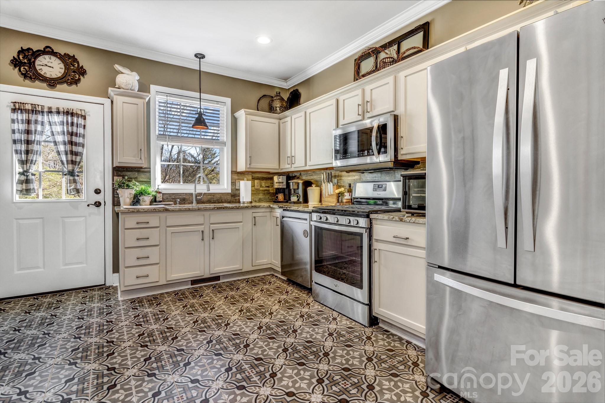 25 Union Chapel Road Weaverville, NC 28787 - Photo 14 of 47 a kitchen with stainless steel appliances a stove a sink and a refrigerator