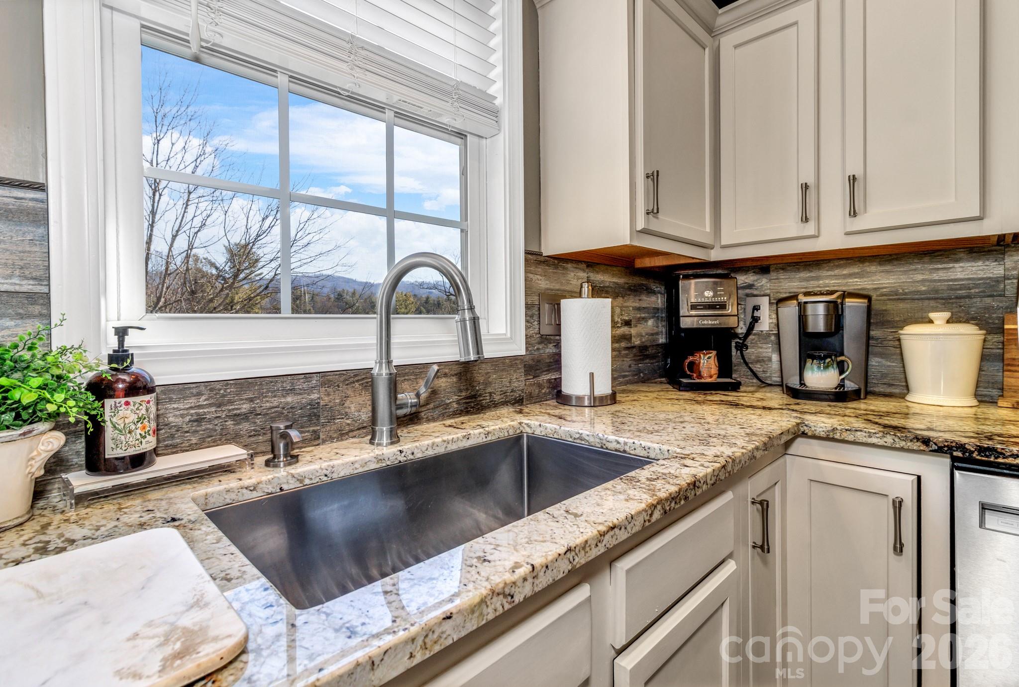 25 Union Chapel Road Weaverville, NC 28787 - Photo 15 of 43 a kitchen with granite countertop a sink and a counter top space