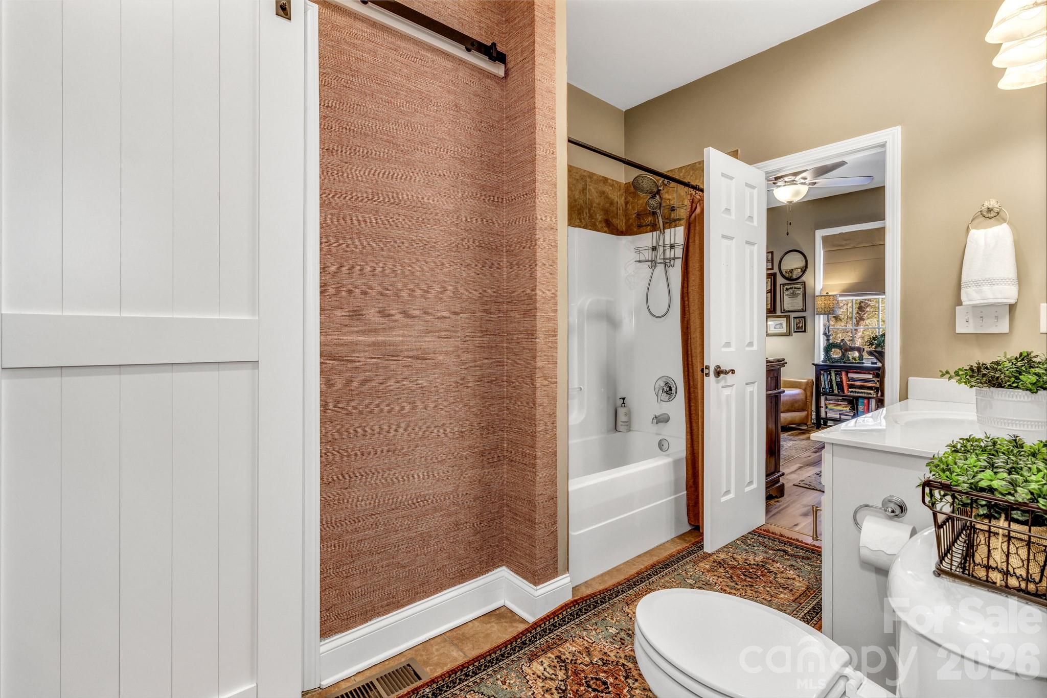 25 Union Chapel Road Weaverville, NC 28787 - Photo 21 of 43 a bathroom with a granite countertop sink mirror vanity and toilet