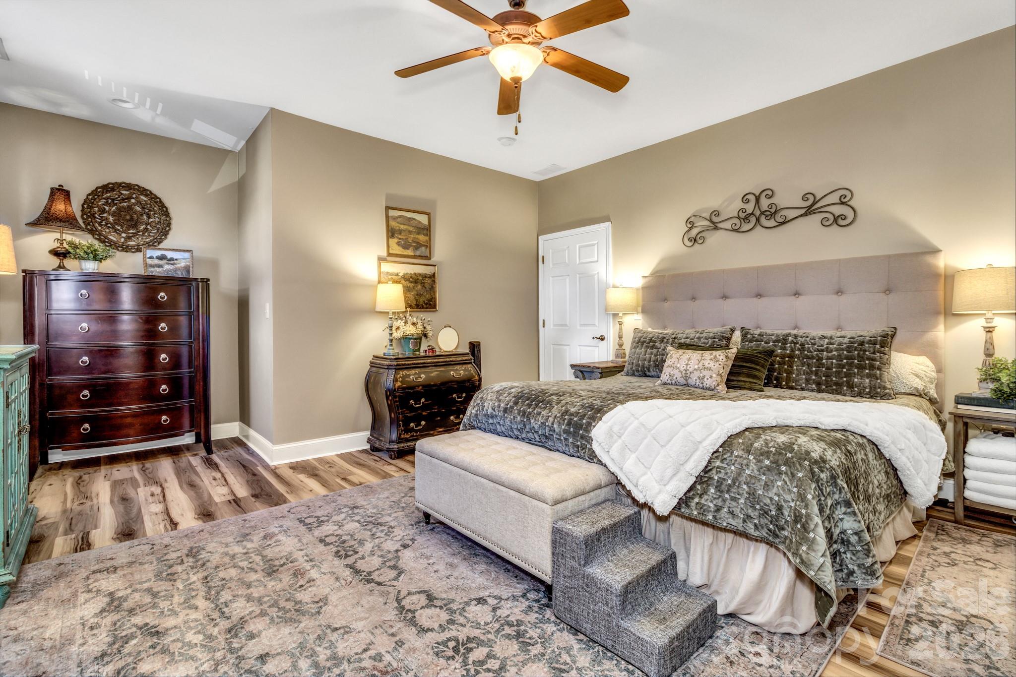 25 Union Chapel Road Weaverville, NC 28787 - Photo 24 of 43 a bedroom with a bed and ceiling fan